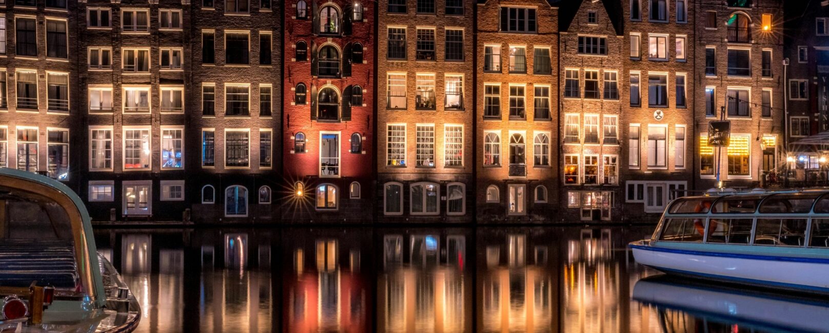 Historic Amsterdam canal houses at night