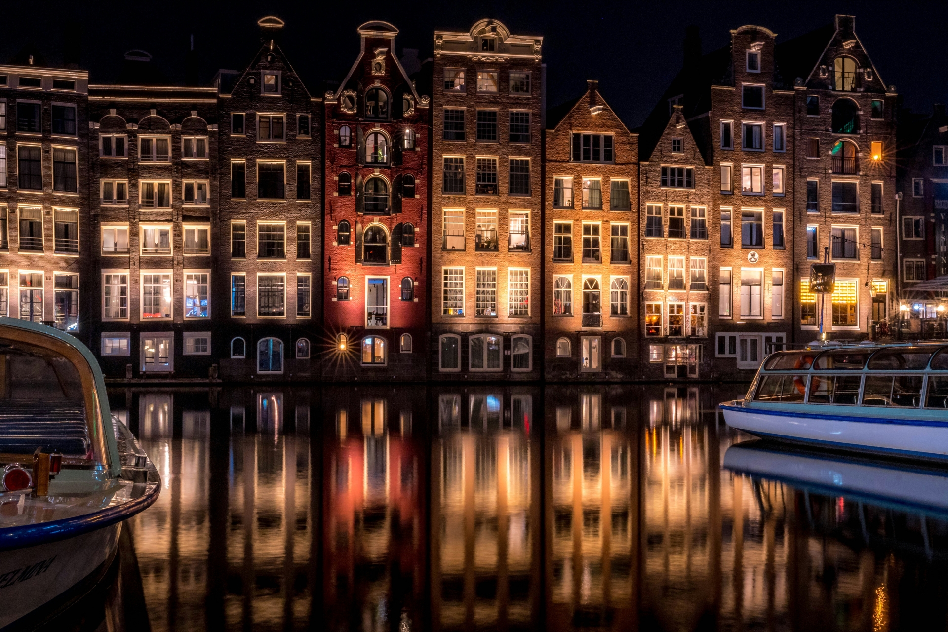 Historic Amsterdam canal houses at night